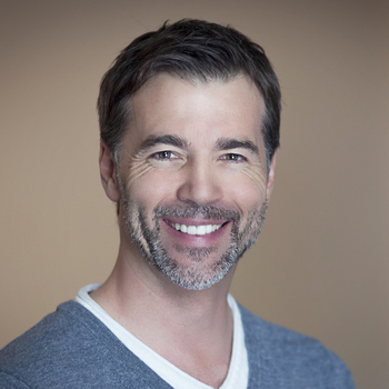 A man smiles to show how Porcelain Veneers from our Beaverton cosmetic dentist can enhance your smile.