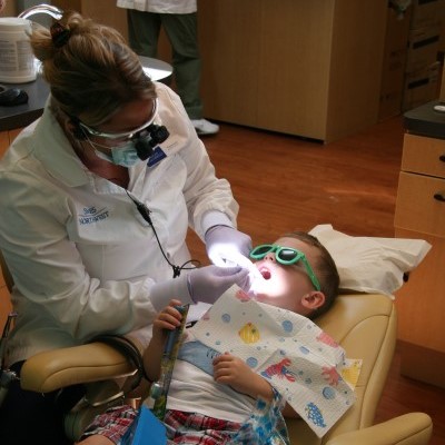 Dental hygienist checking a patient's myobraces placement